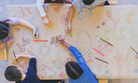 Group of children color environmentally conscious mural