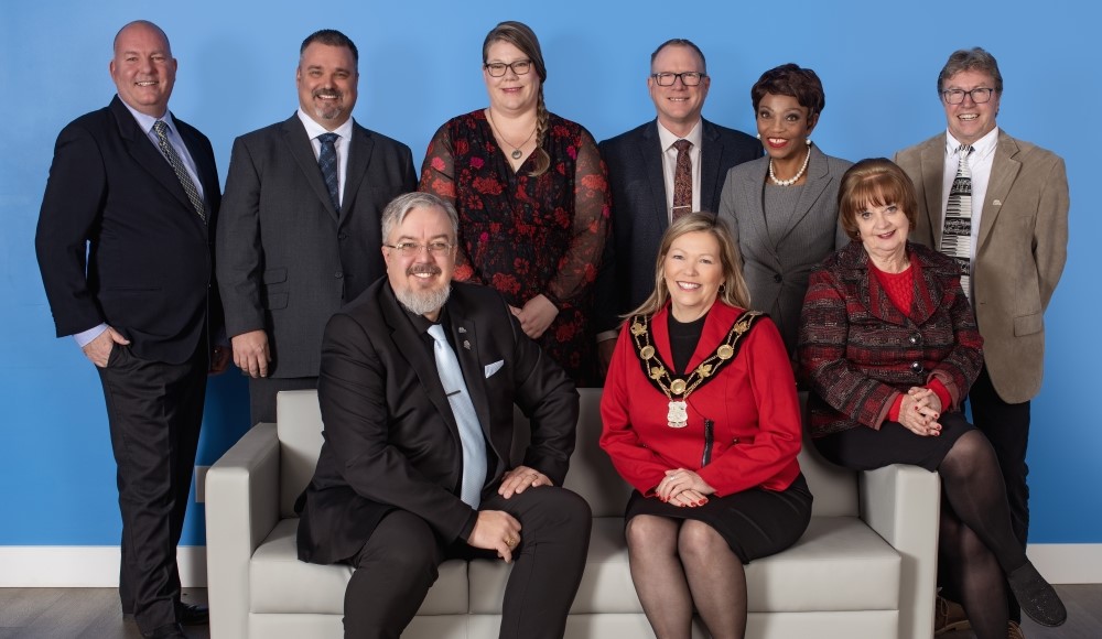 Top row, standing, from left: Robert Saunders, Ward 6; Fred Drodge, Ward 7; Jennifer Richardson, Ward 3; Kevin Eisses, Ward 1; Grace Constantine, Ward 2;Alex Waters, Ward 4. Bottom row, seated, from left: Deputy Mayor Kenneth Fowler; Mayor Lynn Dollin; Linda Zanella, Ward 5 Group photo of council members