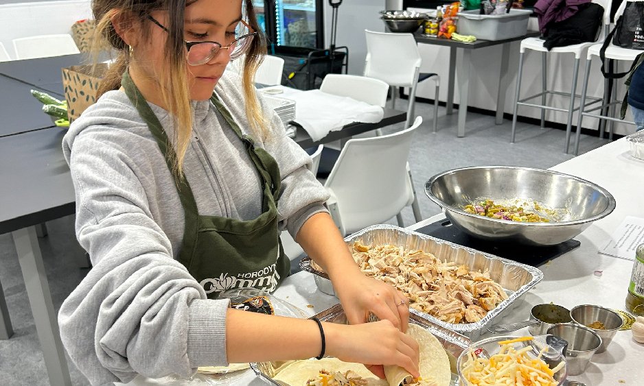 Girl cooking in community kitchen