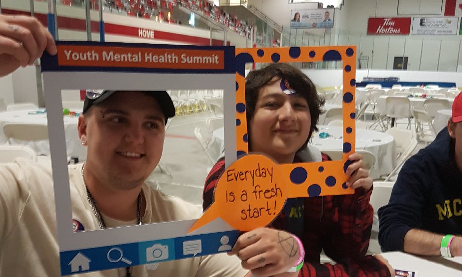 Teen boys holding up selfie frames promoting mental health