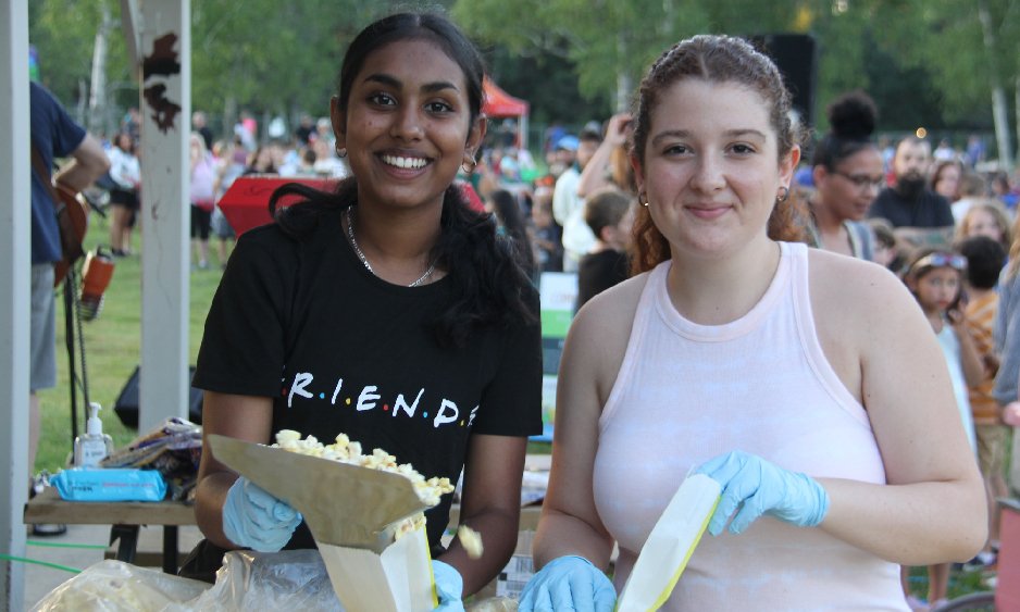 Teen girls volunteering at outdoor movie night