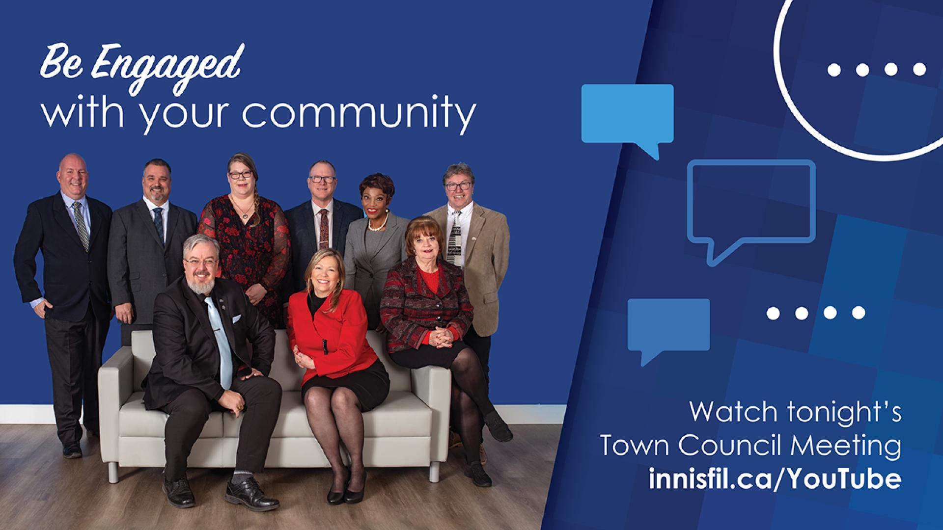 Group of seven men and two women in formal attire, sitting and standing on a couch.