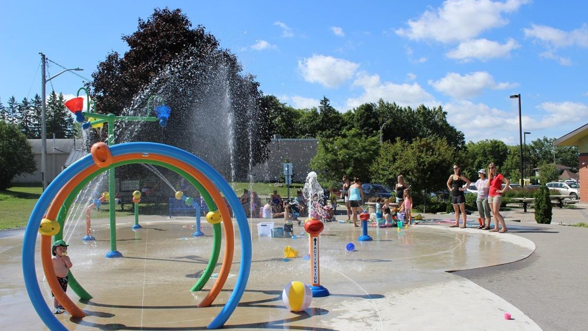Splashpad with water spouts, circular fountains, and other fun elements