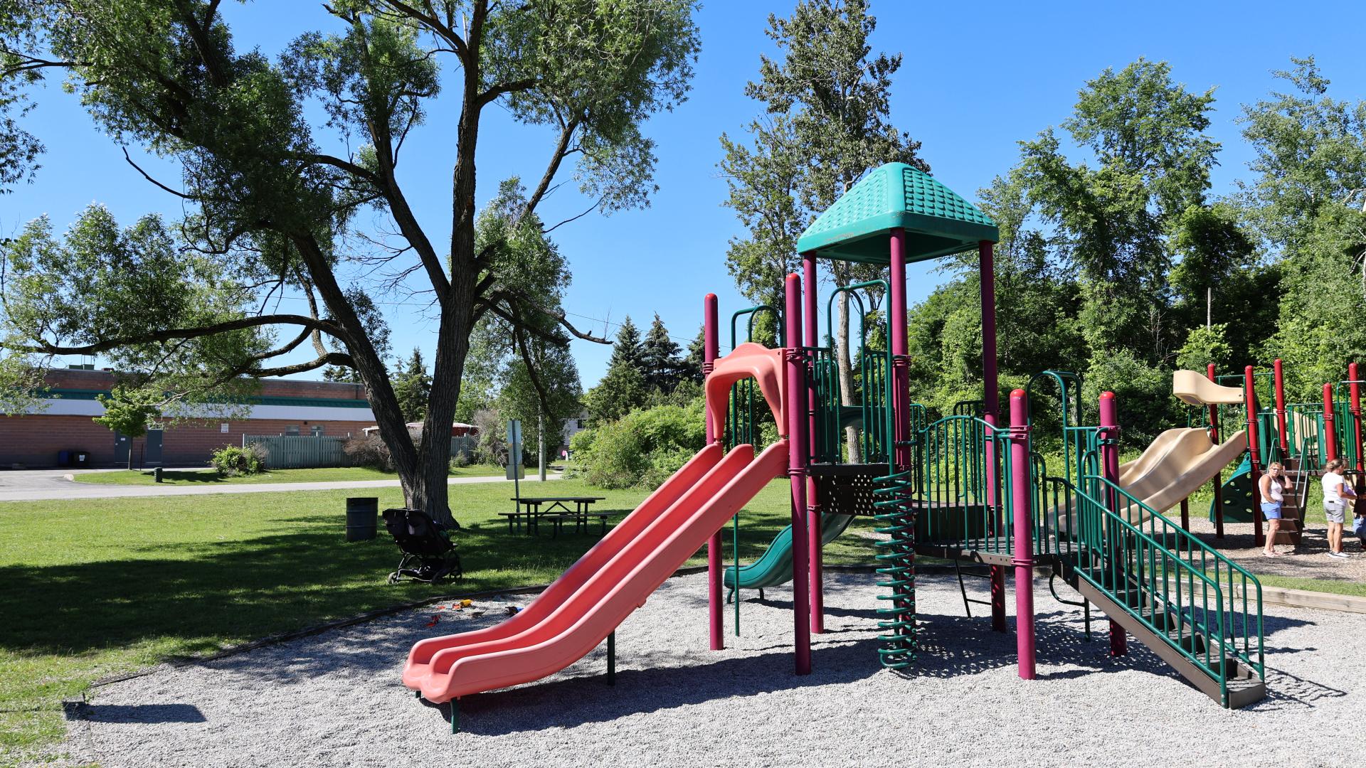 Colourful playground equipment with trees