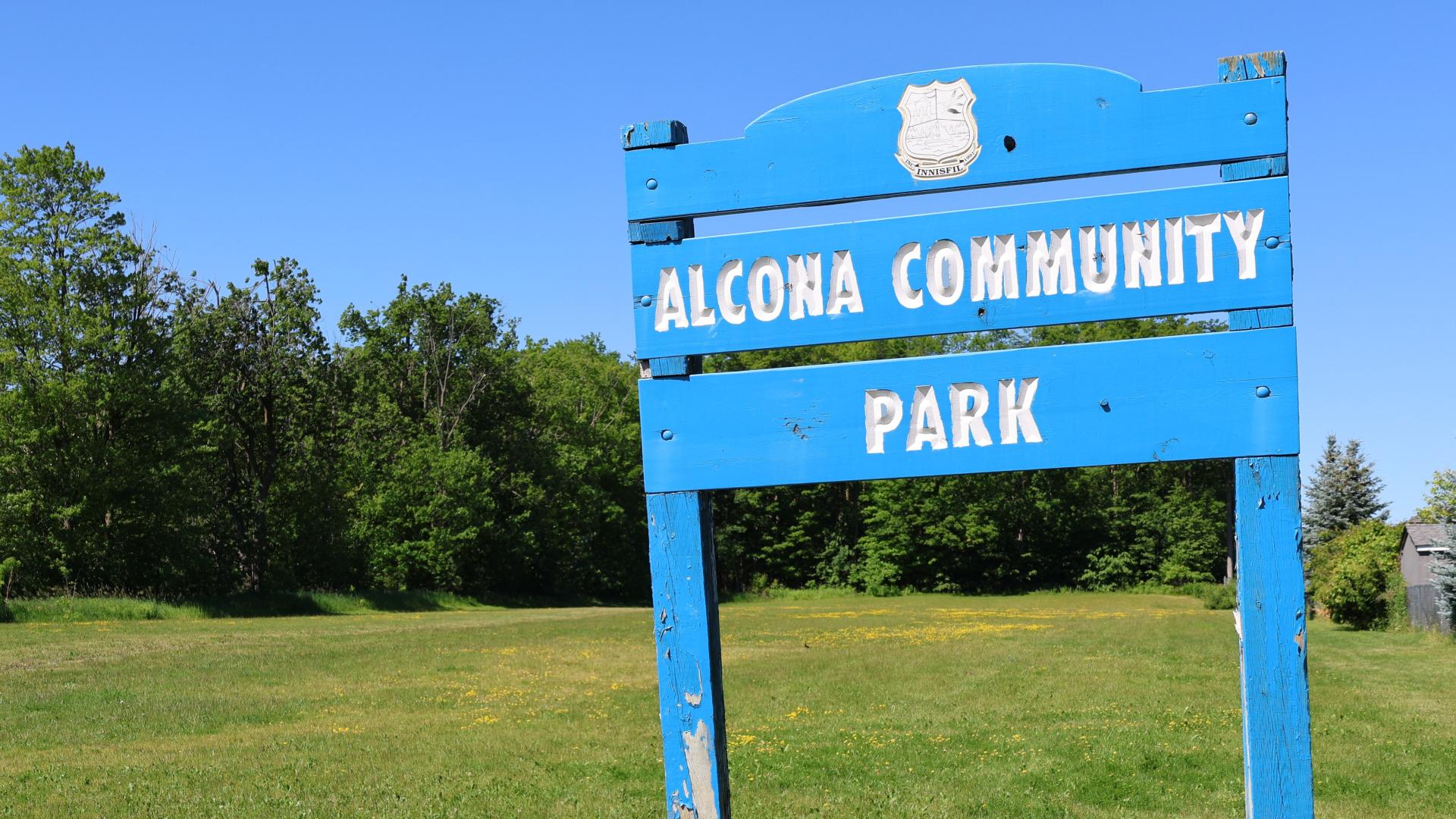 Open field with park sign