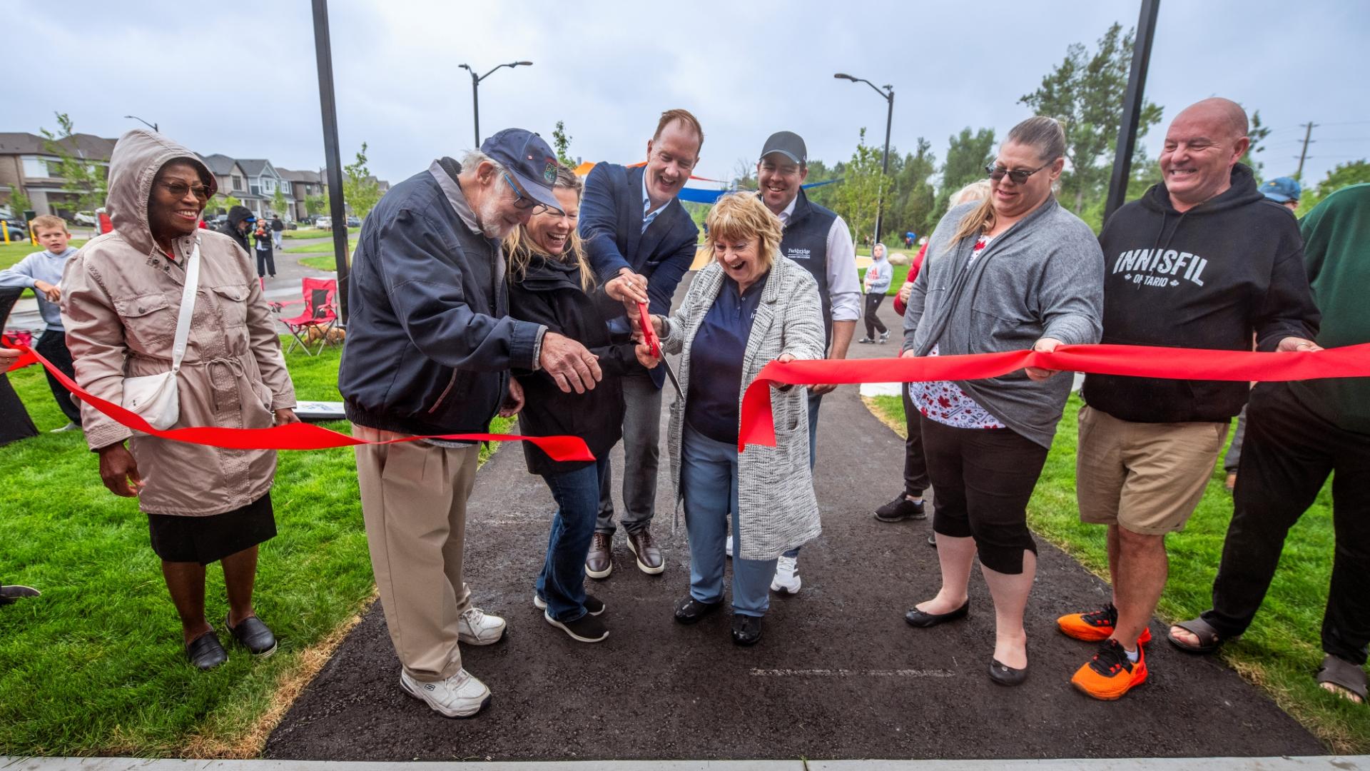 Group of council and community members cutting ribbon at grand opening of Jackson Park
