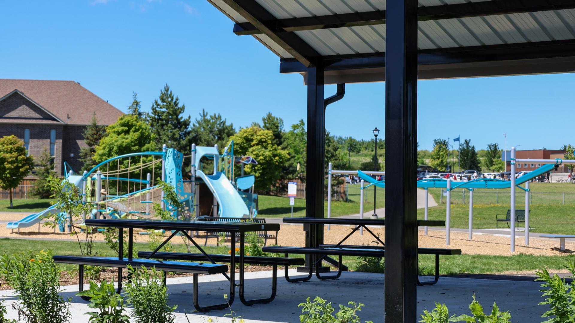 Vibrant new playground equipment and gazebo at Previn Court Park with slides, picnic tables and climbing features