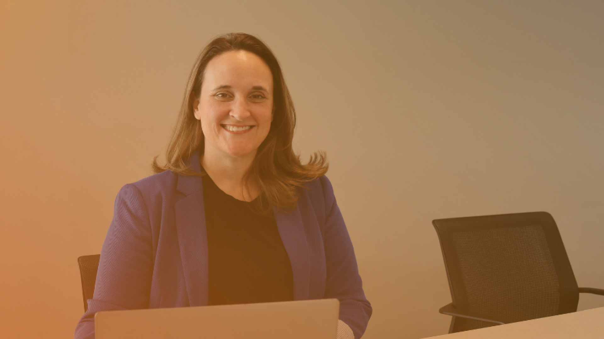 woman sitting at a desk smiling