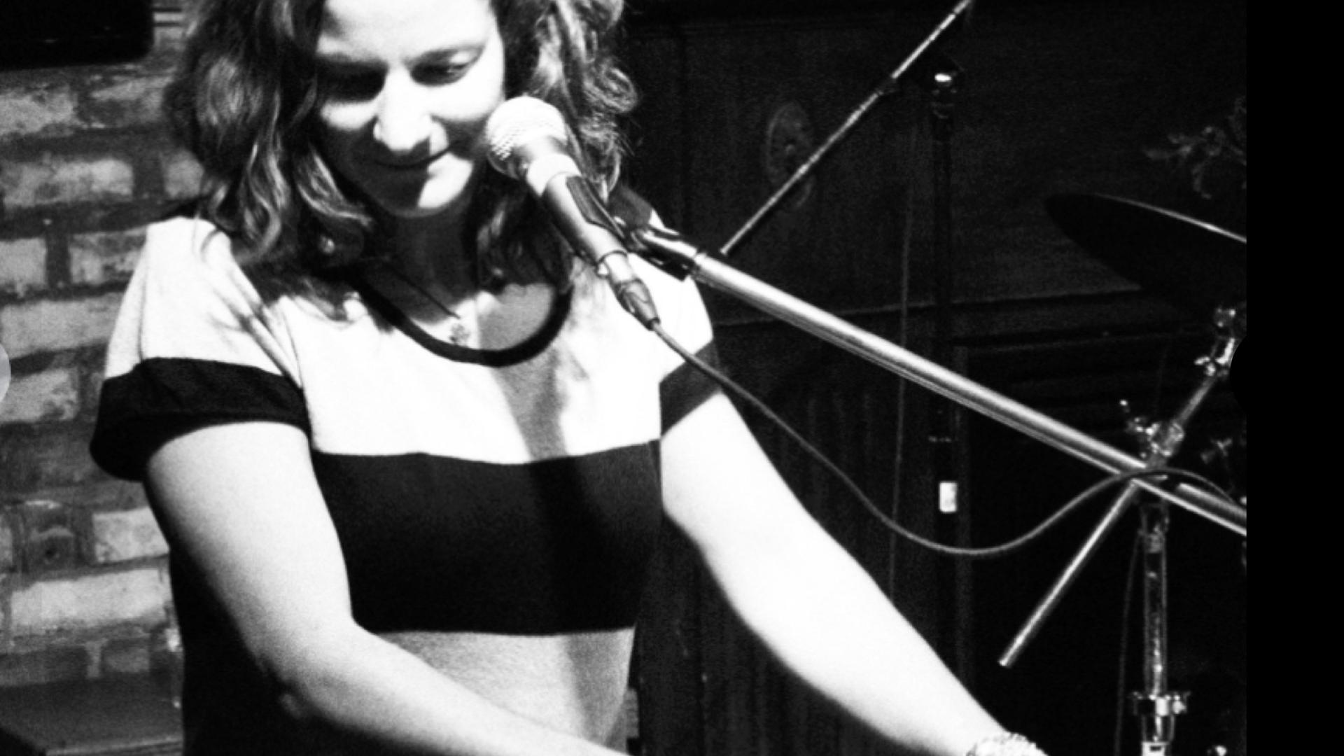 Woman named Angie Nussey playing the keyboard at concert