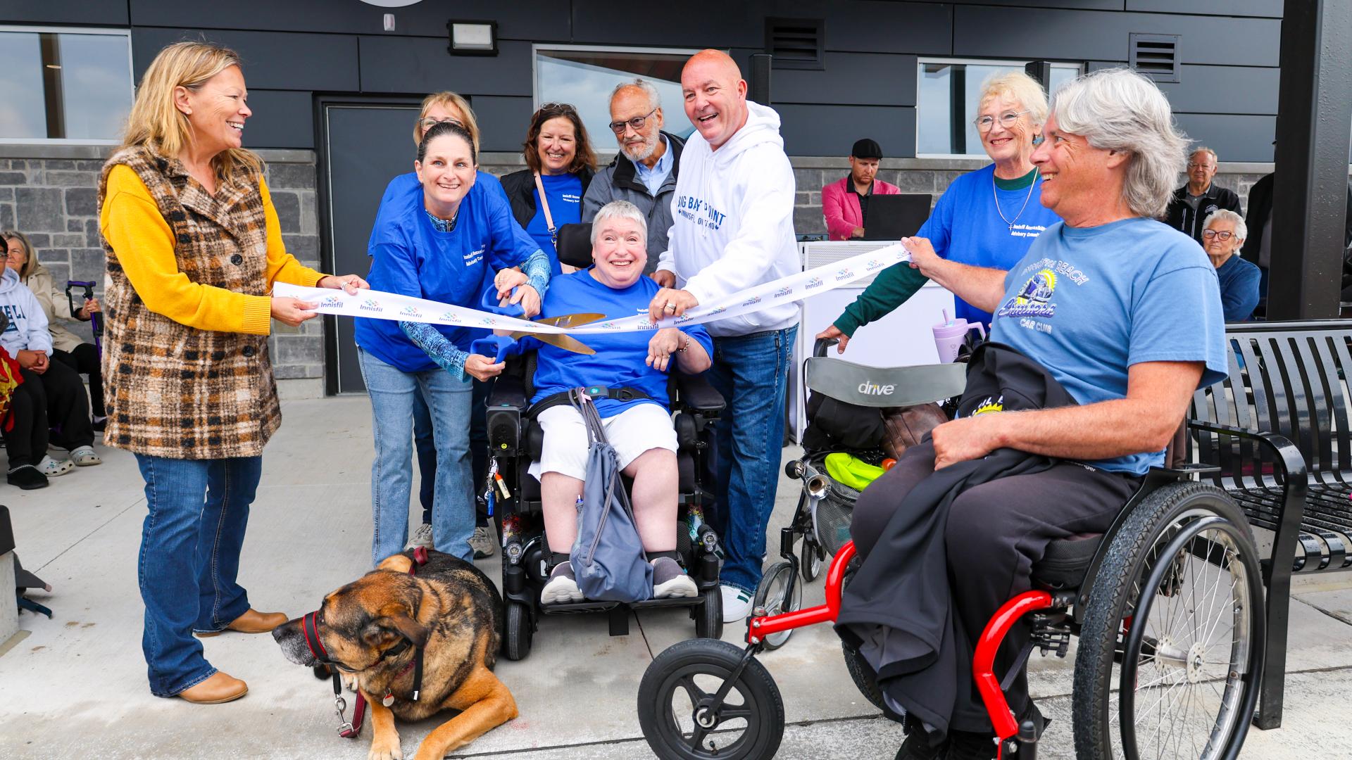 Members of the Innisfil Accessibility Advisory Committee cutting ribbon in celebration 