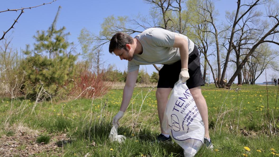 Man picking up waste at park