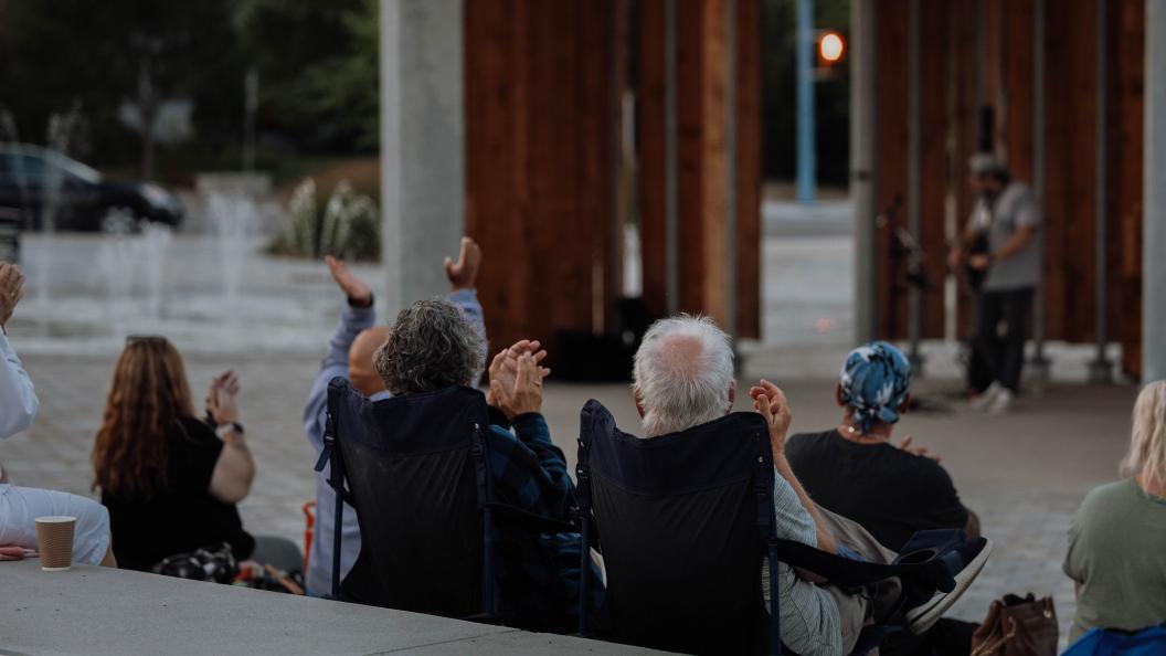 Crowd watching musician perform at Town Square