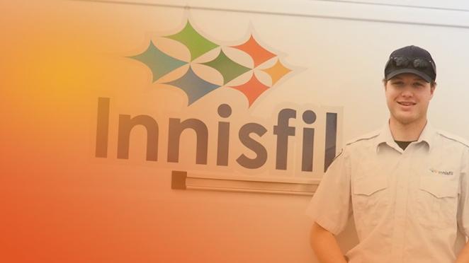 smiling employee standing outside of town of Innisfil vehicle