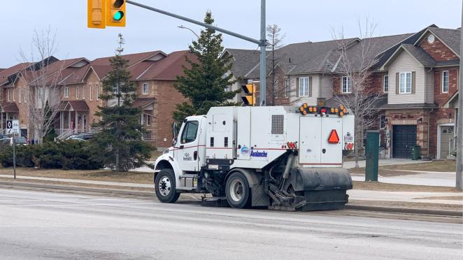 Street sweeper driving down road