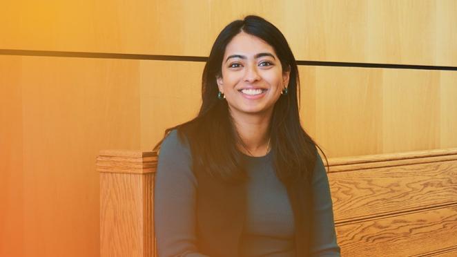 employee smiling on bench