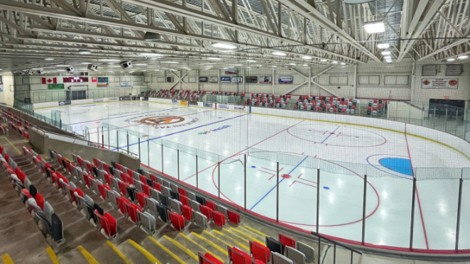 Picture of an outdoor ice skating rink taken from the top of the stands