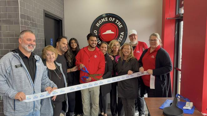 Innisfil Council and community members cutting ribbon at business opening ceremony