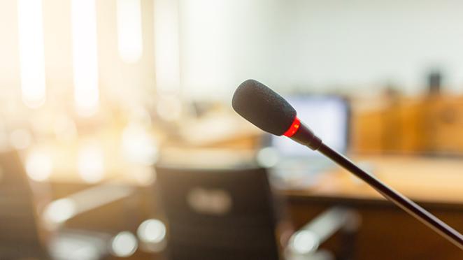 Microphone over the blurred meeting