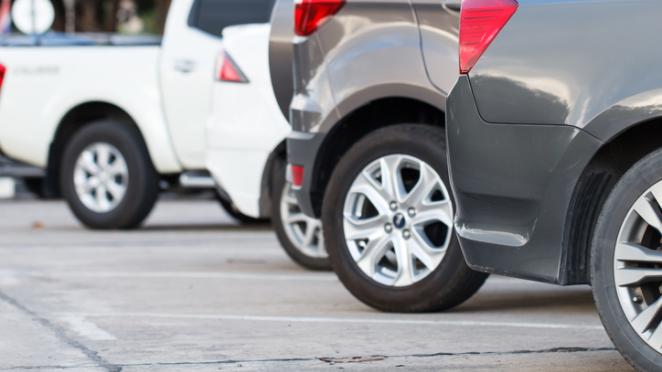 Cars parked in line outdoors