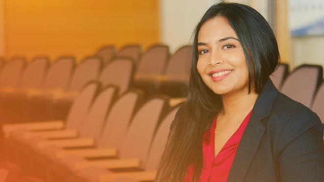 smiling development engineer seated in the Town's Council Chambers