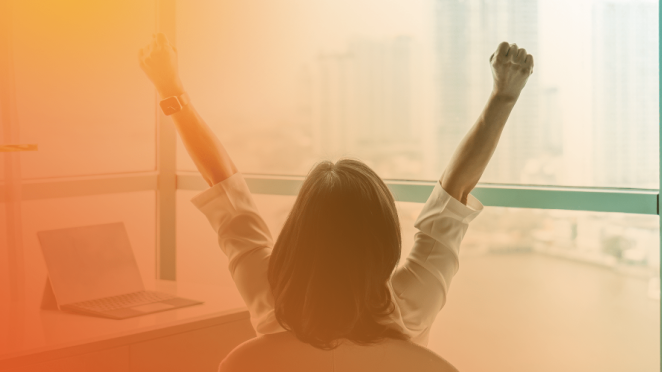 Happy business woman sitting in chair with arms stretched out