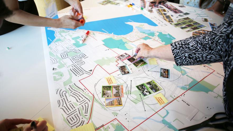 Group of people placing photos on map