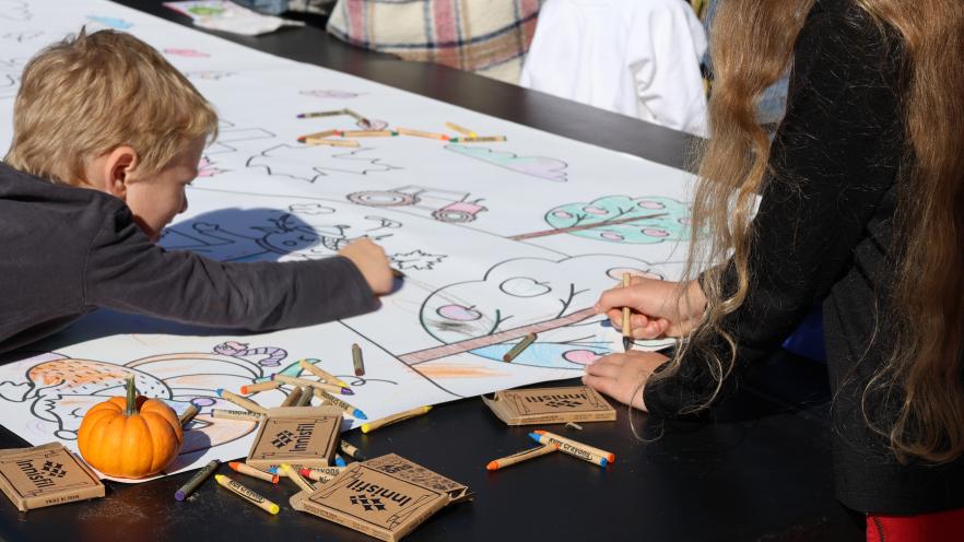 Young child colouring on a colouring sheet
