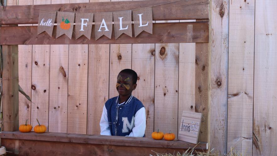 Boy poising in a wooden frame photo op