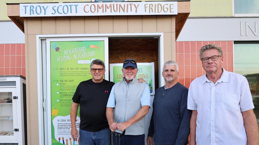 Donors standing near Troy Scott Community Fridge