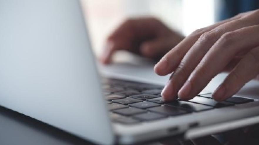 Close up of hands typing on laptop keyboard 