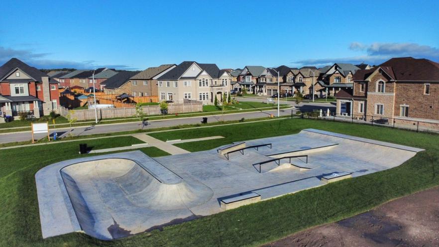 Arial view of a skatepark with handrails, ledges, bowl, and other skatepark elements