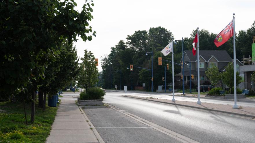 Empty sidewalk beside a street