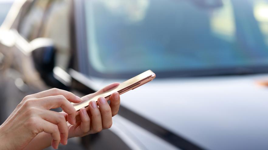 Person using mobile phone to order transit ride