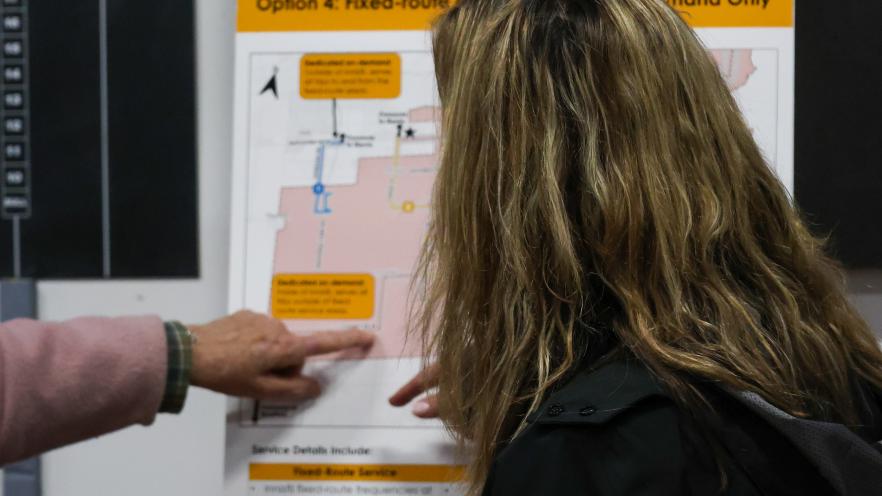 Public open house attendants viewing boards about the Transit Master Plan
