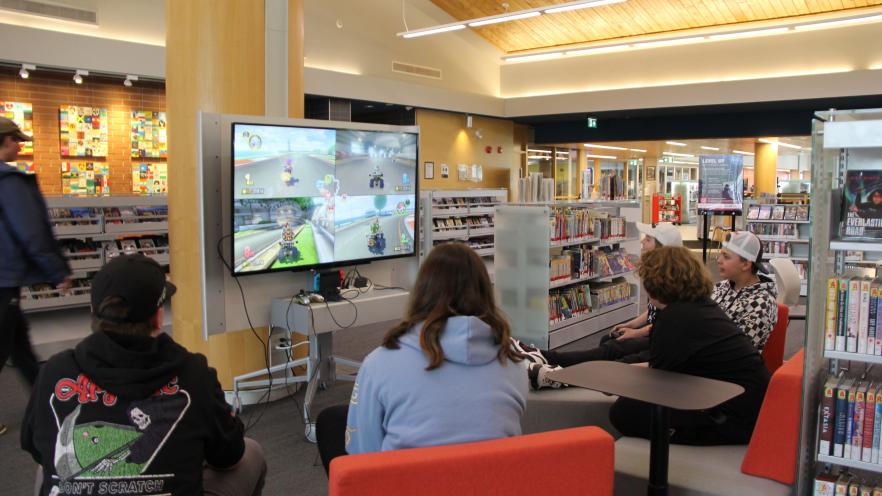 Teens playing video games at the library