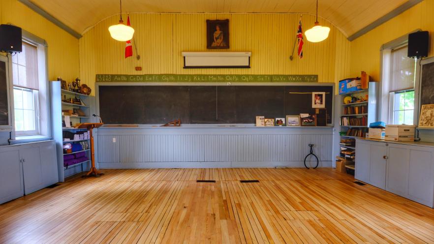 Inside Knock Schoolhouse, a renovated community hall with wooden floors and historic features