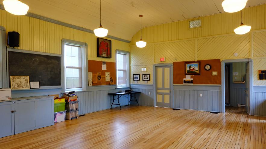 Inside Knock Schoolhouse, showing heritage features and blue paneled walls