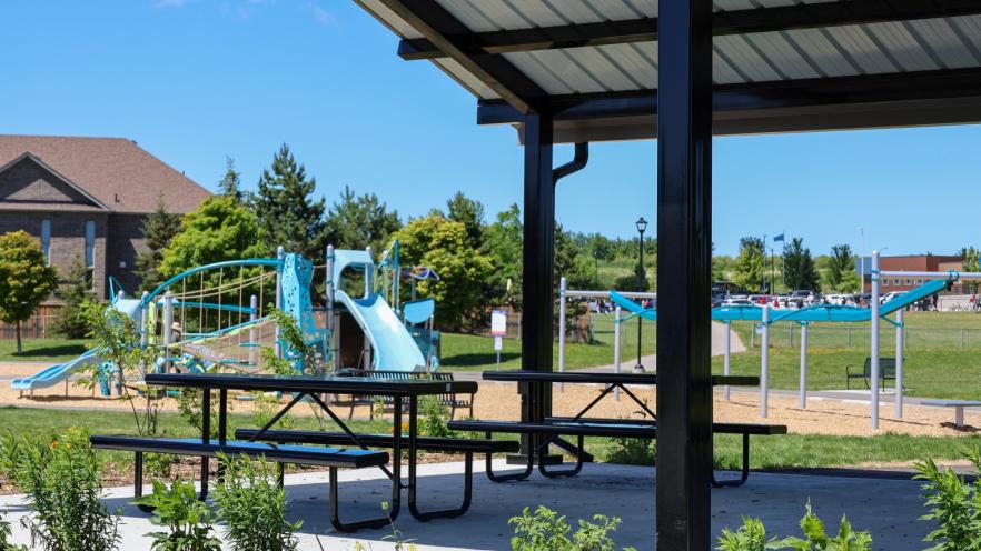 Vibrant new playground equipment and gazebo at Previn Court Park with slides, picnic tables and climbing features
