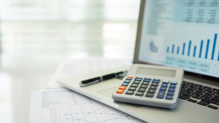 Calculator, account statement and business report with financial budget portfolio show on screen laptop computer. 