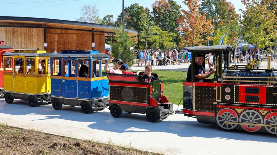Kids riding trackless train at fall event
