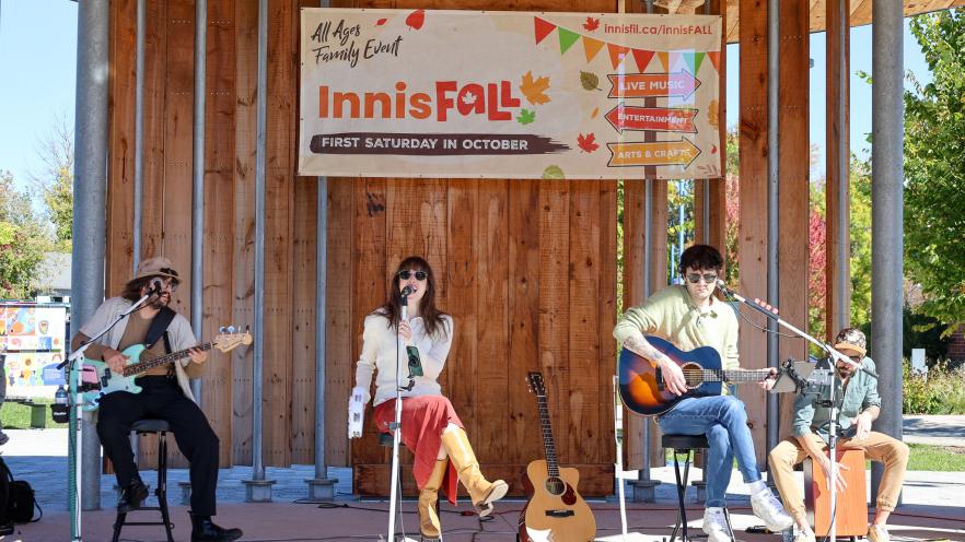 Band of four musicians playing outdoor show at InnisFall