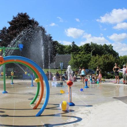 Splashpad with water spouts, circular fountains, and other fun elements