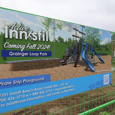 Sign installed on a fence, it reads "Coming Fall 2024! Grainger Loop Park. Pirate Ship Playground!"