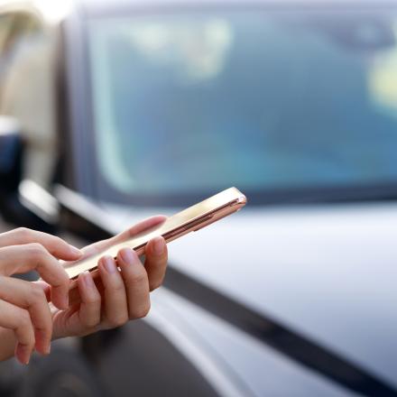 Person using mobile phone to order transit ride