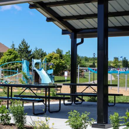 Vibrant new playground equipment and gazebo at Previn Court Park with slides, picnic tables and climbing features