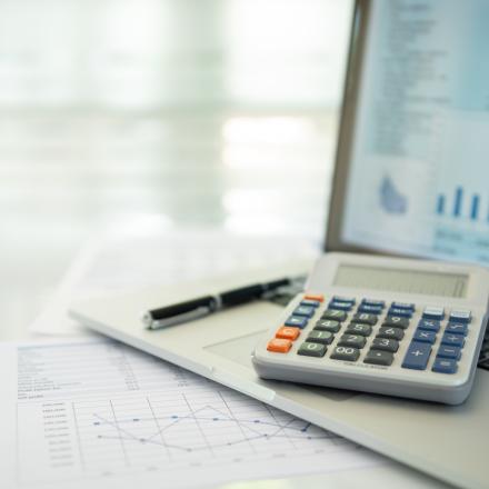 Calculator, account statement and business report with financial budget portfolio show on screen laptop computer.