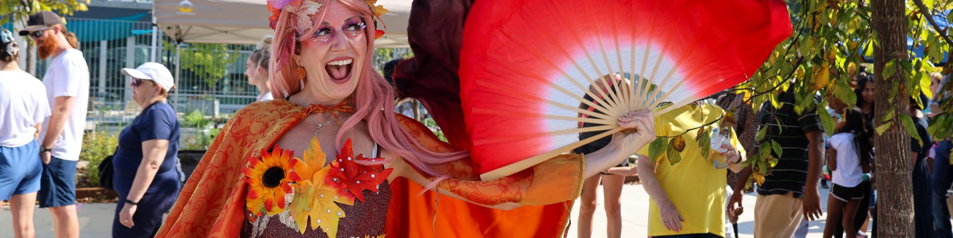 Fall-themed character posing at fall event