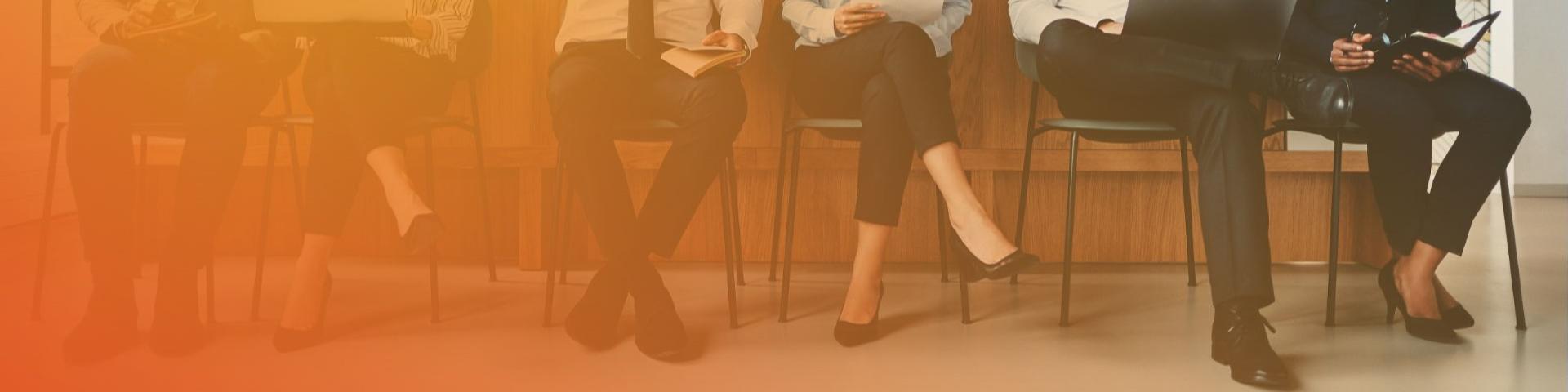 People sitting in chairs waiting for an interview