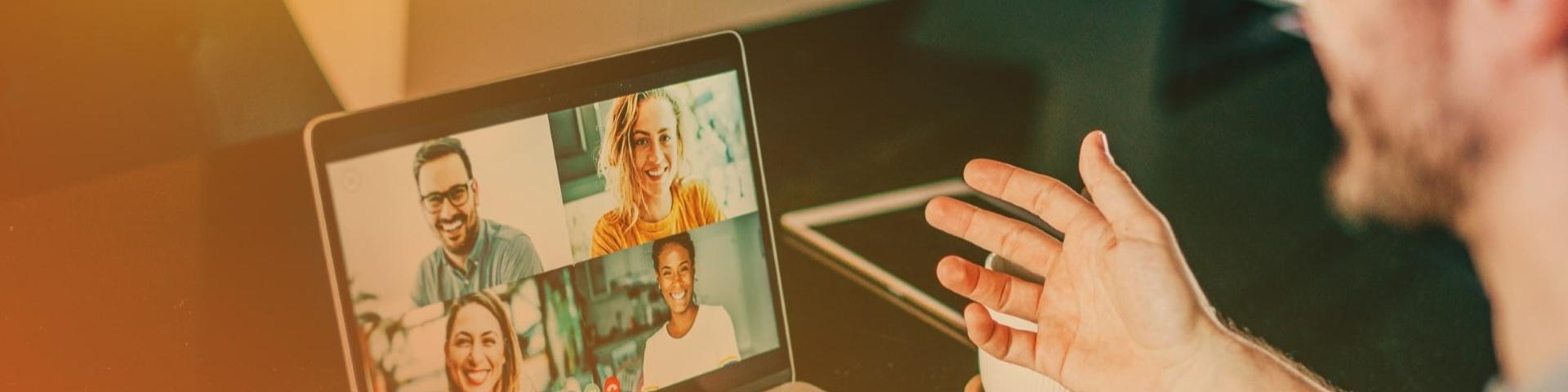 Man talking to laptop during virtual meeting
